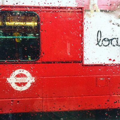 London as we know it. The London bus keeps life moving despite a summer rain shower.