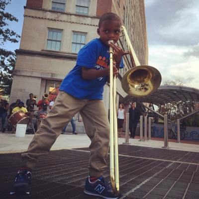 A young boy plays a trombone in Washington D.C.’s historic Dupont area. Summers in the city are packed with free music concerts and street performances.